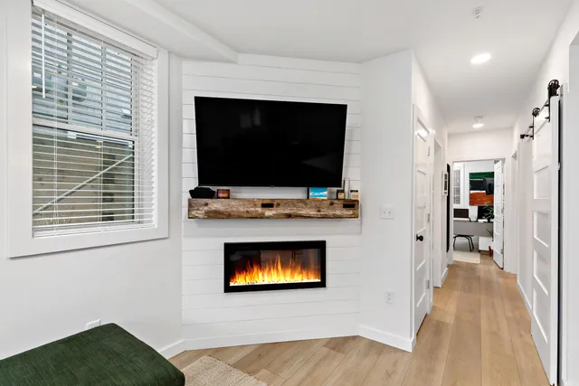 a living room with a flat screen tv and a fireplace