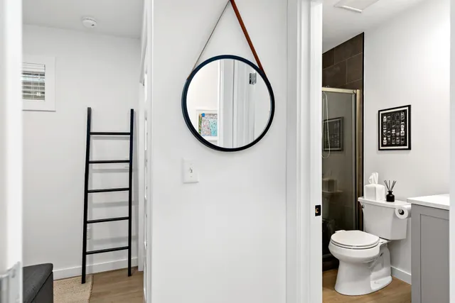 a bathroom with a toilet a sink and a mirror