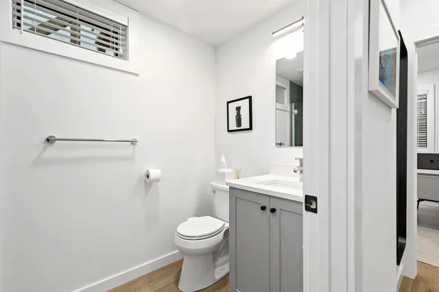 a bathroom with a toilet a sink and mirror