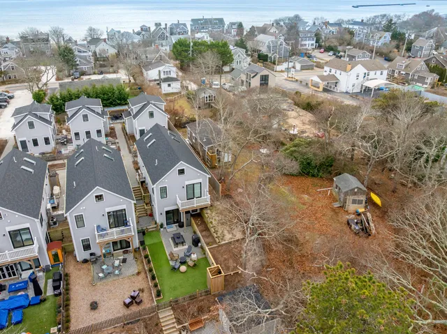 an aerial view of residential houses with outdoor space