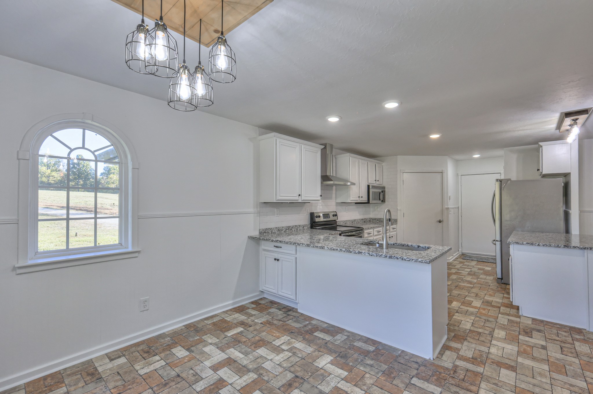 1380 Haley Road Watertown, TN 37184 - Photo 23 of 95 a large kitchen with kitchen island a chandelier stainless steel appliances cabinets and a counter top space