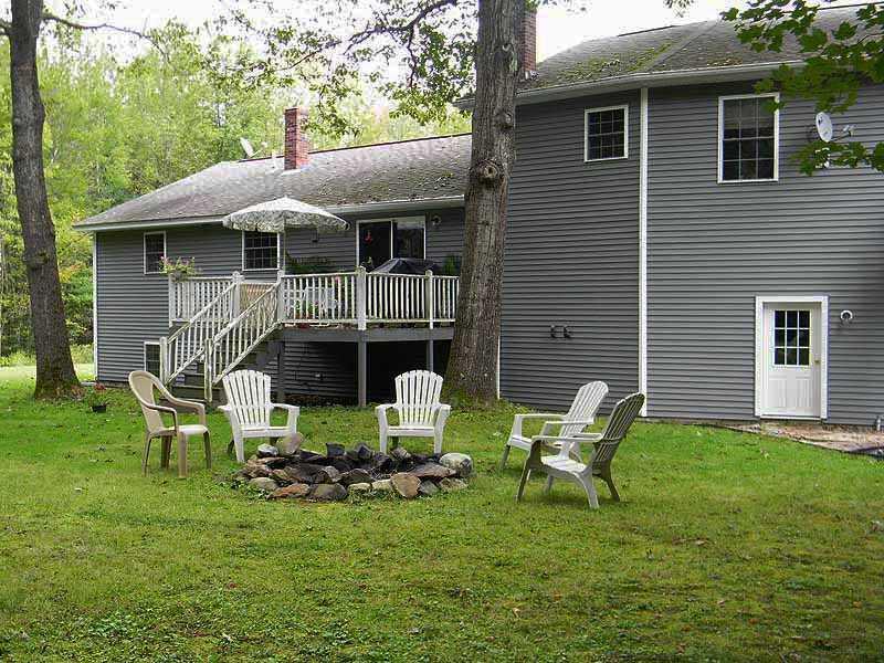 47 Gilman Road Monmouth, ME 04259 - Photo 30 of 35 Exterior Back. Deck and fire pit