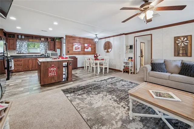a living room with furniture a wooden floor and chandelier
