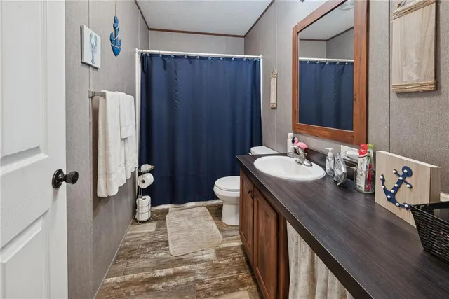 a bathroom with a double vanity sink and a toilet