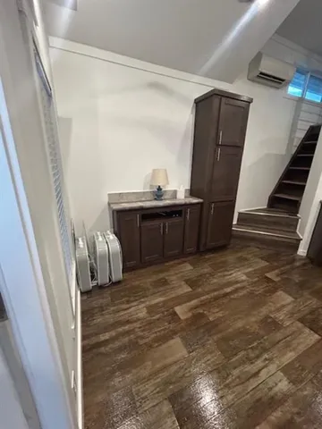 a view of bedroom with furniture and wooden floor