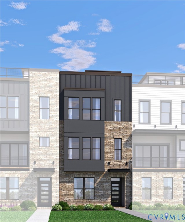 a front view of a residential apartment building with a yard