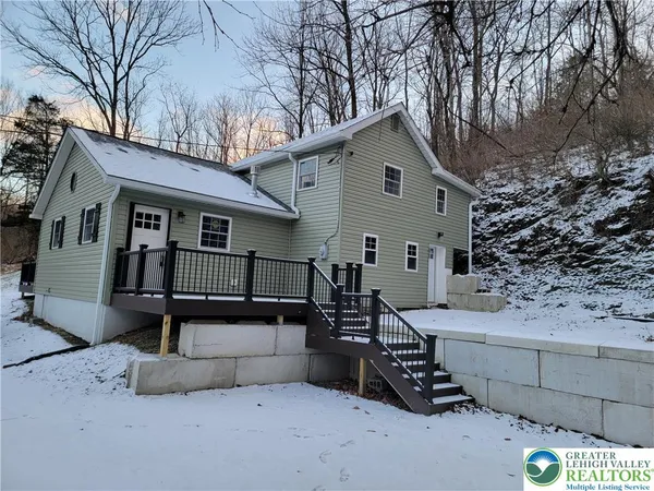 a view of a house with a yard and roof deck