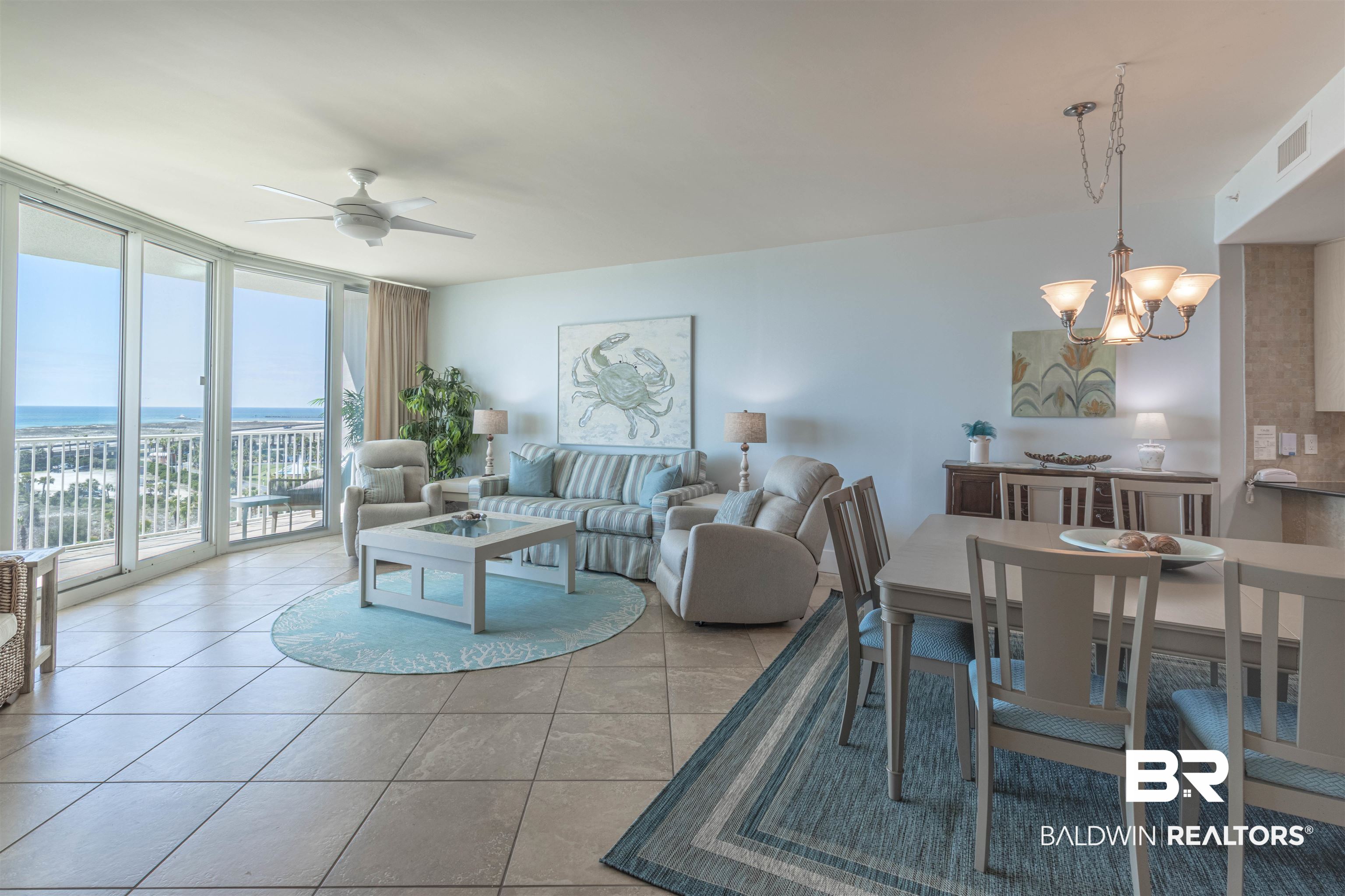 28107 Perdido Beach Boulevard, Unit D714 Orange Beach, AL 36561 - Photo 12 of 88 Living area with tile patterned floors, visible vents, expansive windows, and ceiling fan with notable chandelier