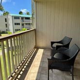 a balcony view with couple of chairs