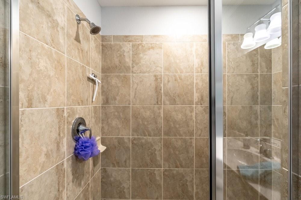 9578 Trevi Court, Unit 5142 Naples, FL 34113 - Photo 15 of 49 a bathroom with a shower