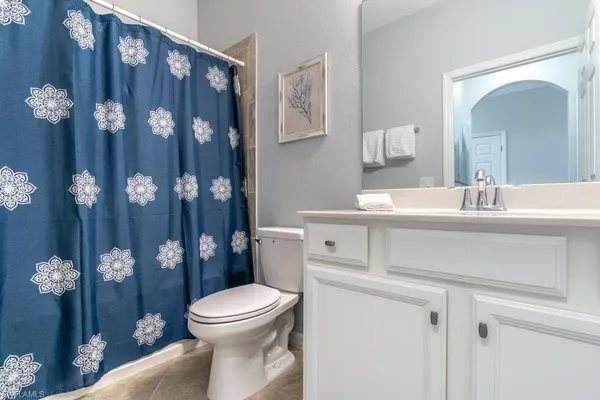 a bathroom with a sink vanity mirror and toilet