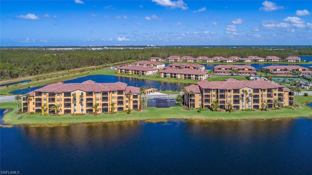 9578 Trevi Court, Unit 5142 Naples, FL 34113 - Photo 30 of 49 a view of a city with lawn chairs and large trees