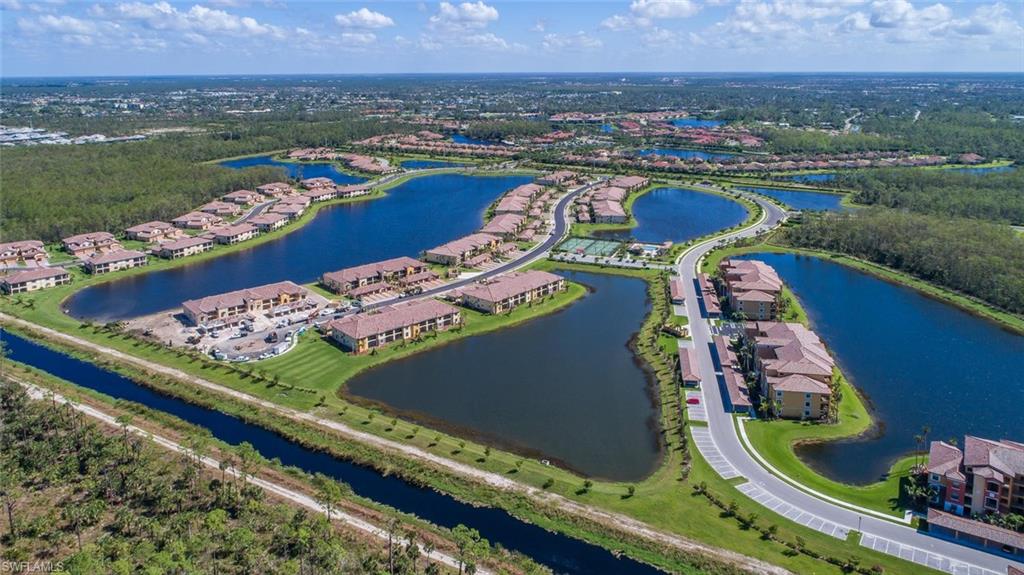 9578 Trevi Court, Unit 5142 Naples, FL 34113 - Photo 32 of 49 an aerial view of a pool patio yard and mountain view in back