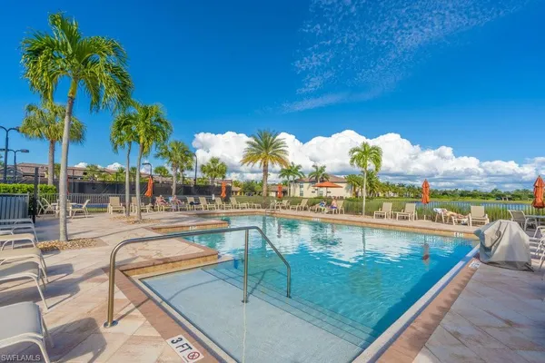a view of swimming pool with outdoor seating and city view