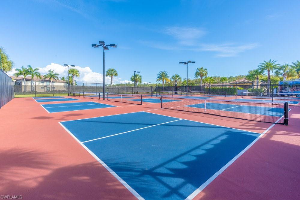 9578 Trevi Court, Unit 5142 Naples, FL 34113 - Photo 35 of 49 a view of an outdoor space and tennis court
