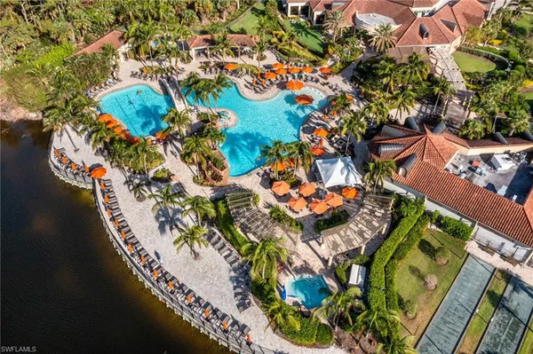 a view of a patio with table and chairs under an umbrella