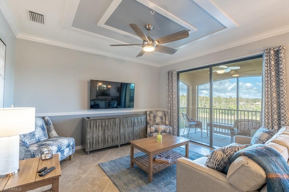 9578 Trevi Court, Unit 5142 Naples, FL 34113 - Photo 10 of 49 a living room with furniture and a window