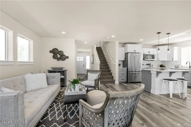 a living room with furniture and a wooden floor