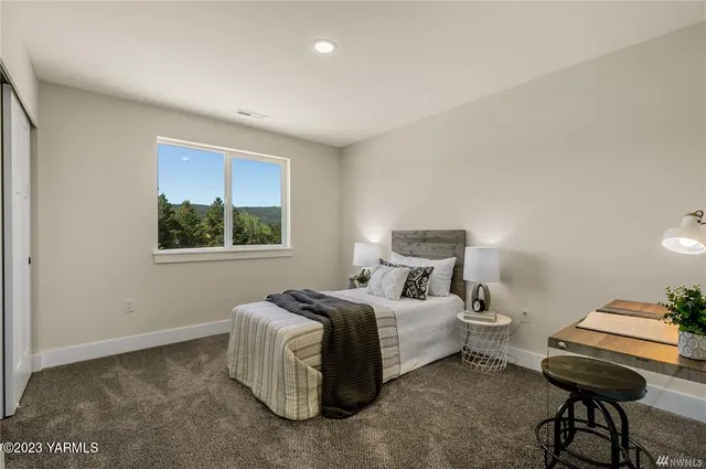 a bedroom with bed and a window