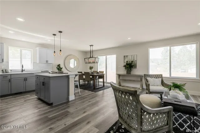a dining room with furniture and wooden floor