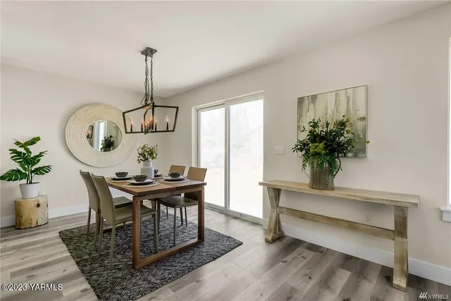 a view of a dining room with furniture window and wooden floor