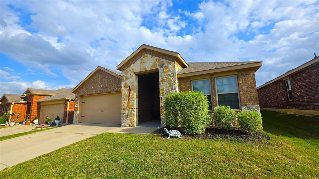 409 Samuel Street Denton, TX 76207 - Photo 2 of 40 a front view of house with yard and trees in the background