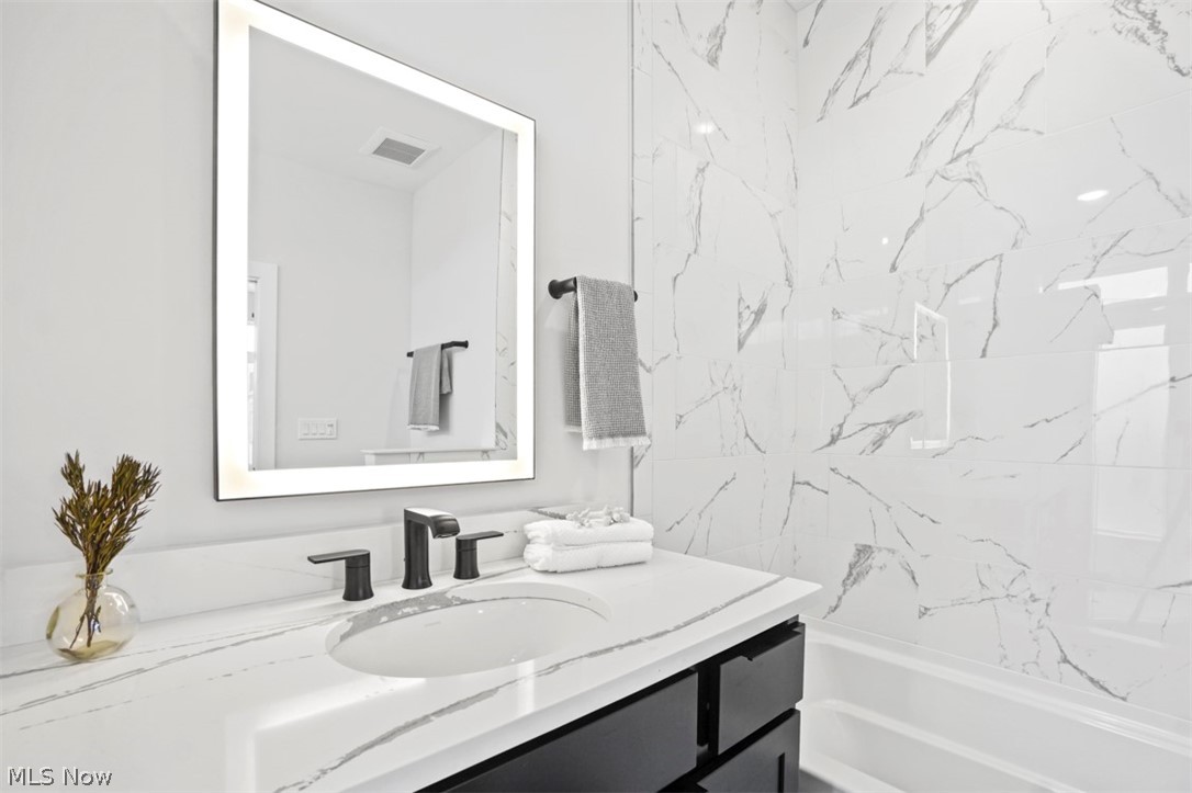 2291 West 19th Street Cleveland, OH 44113 - Photo 24 of 47 Bathroom with tiled shower / bath combo and vanity