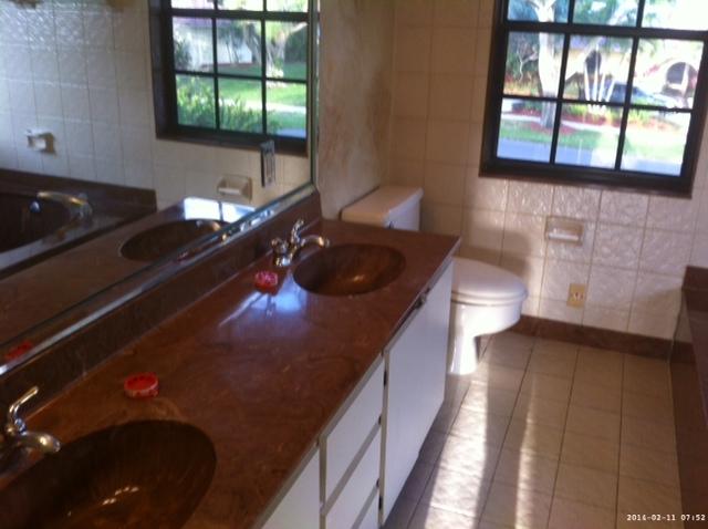 2298 Northwest 35th Street Boca Raton, FL 33431 - Photo 16 of 26 a kitchen with a sink a stove and a window