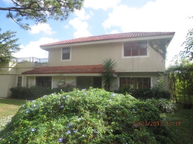 2298 Northwest 35th Street Boca Raton, FL 33431 - Photo 24 of 26 a front view of a house with garden