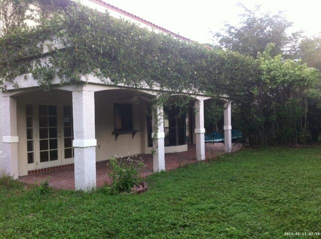 2298 Northwest 35th Street Boca Raton, FL 33431 - Photo 25 of 26 a view of a house with brick walls and a yard with plants