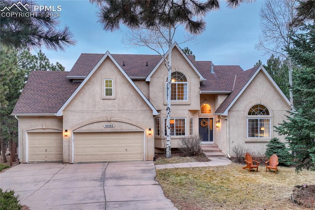 15585 Falcon Ridge Court Colorado Springs, CO 80921 - Photo 1 of 50 a front view of a house with a yard and garage