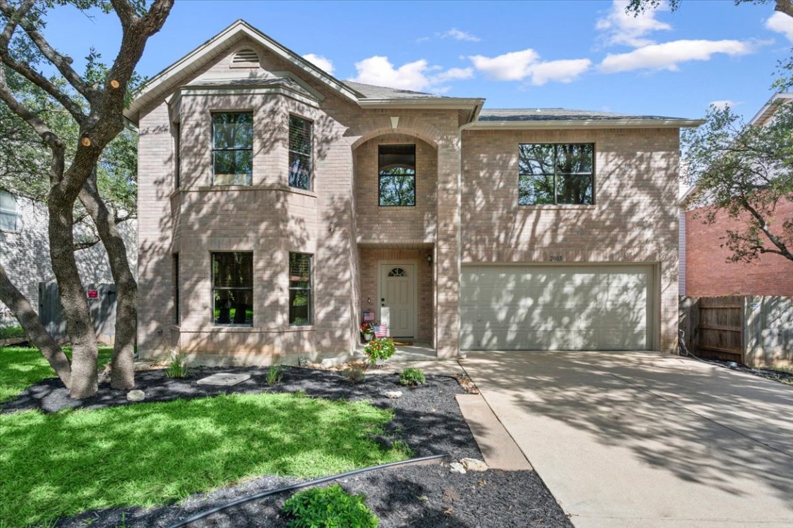 a front view of a house with a yard