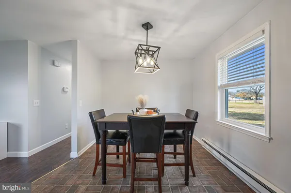 a view of a dining room with a table and chairs
