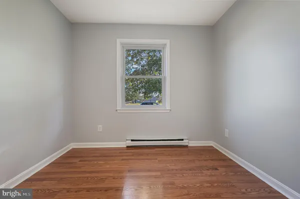 a view of a room with wooden floor and window