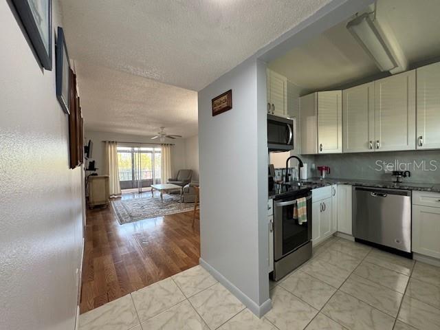 11485 Oakhurst Road, Unit 319 Largo, FL 33774 - Photo 24 of 63 a kitchen with a sink cabinets and stainless steel appliances