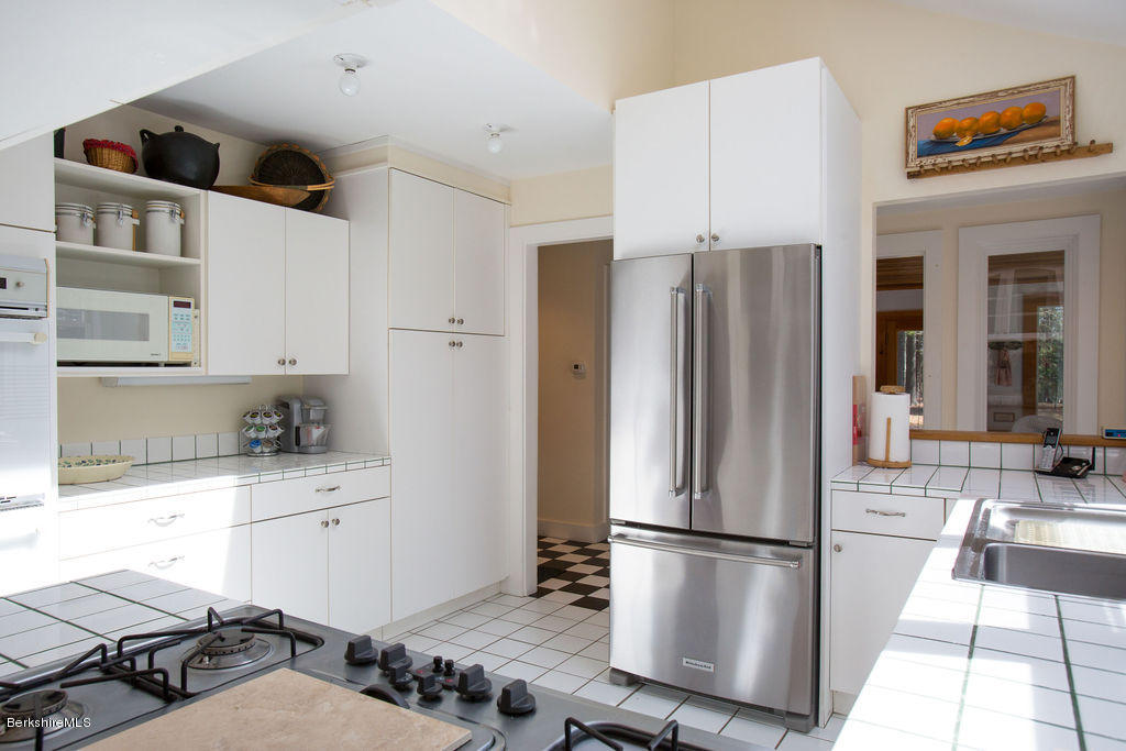 674 Foley Road Sheffield, MA 01257 - Photo 10 of 30 a kitchen with stainless steel appliances a refrigerator and a stove top oven