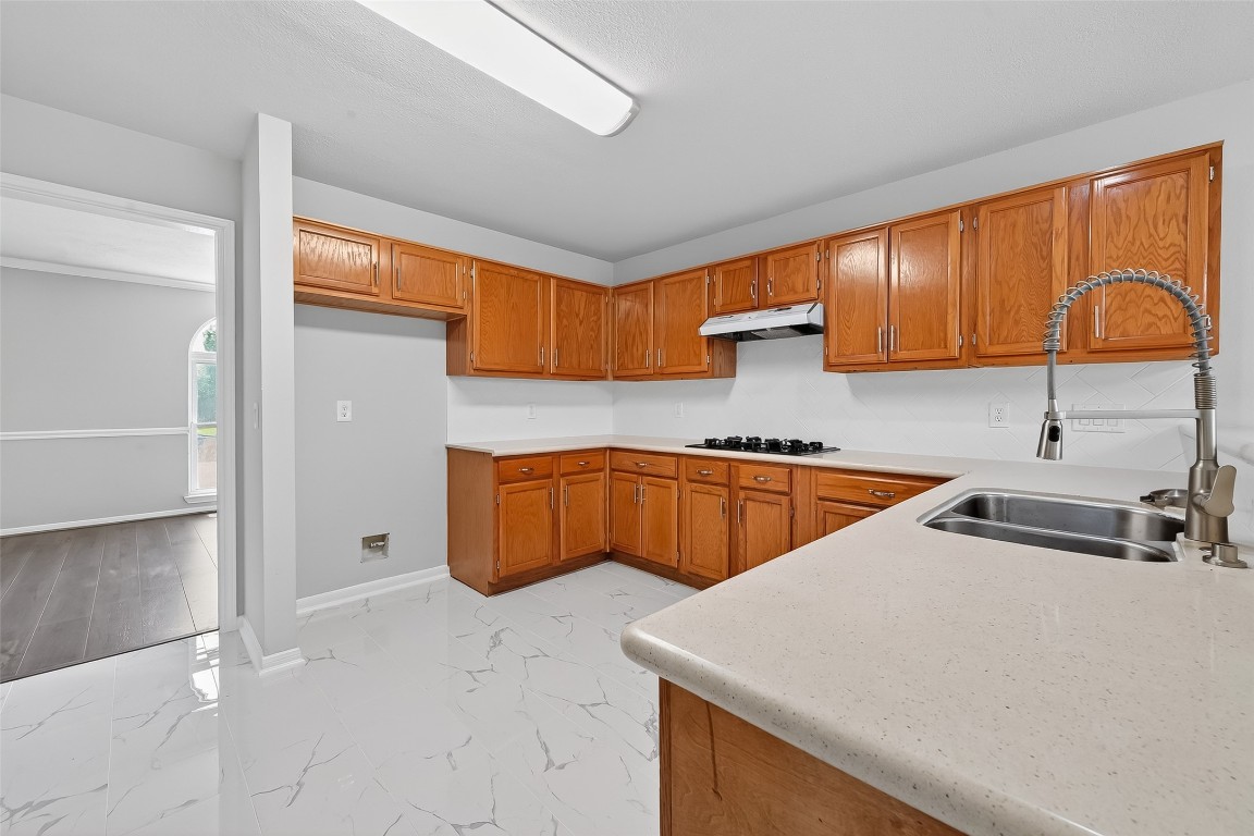 18058 Golden Ridge Drive Houston, TX 77084 - Photo 13 of 35 a kitchen with stainless steel appliances granite countertop a sink a stove and a refrigerator