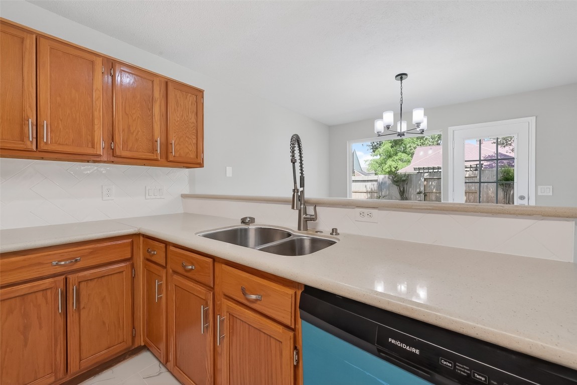 18058 Golden Ridge Drive Houston, TX 77084 - Photo 15 of 35 a kitchen with stainless steel appliances a sink and cabinets