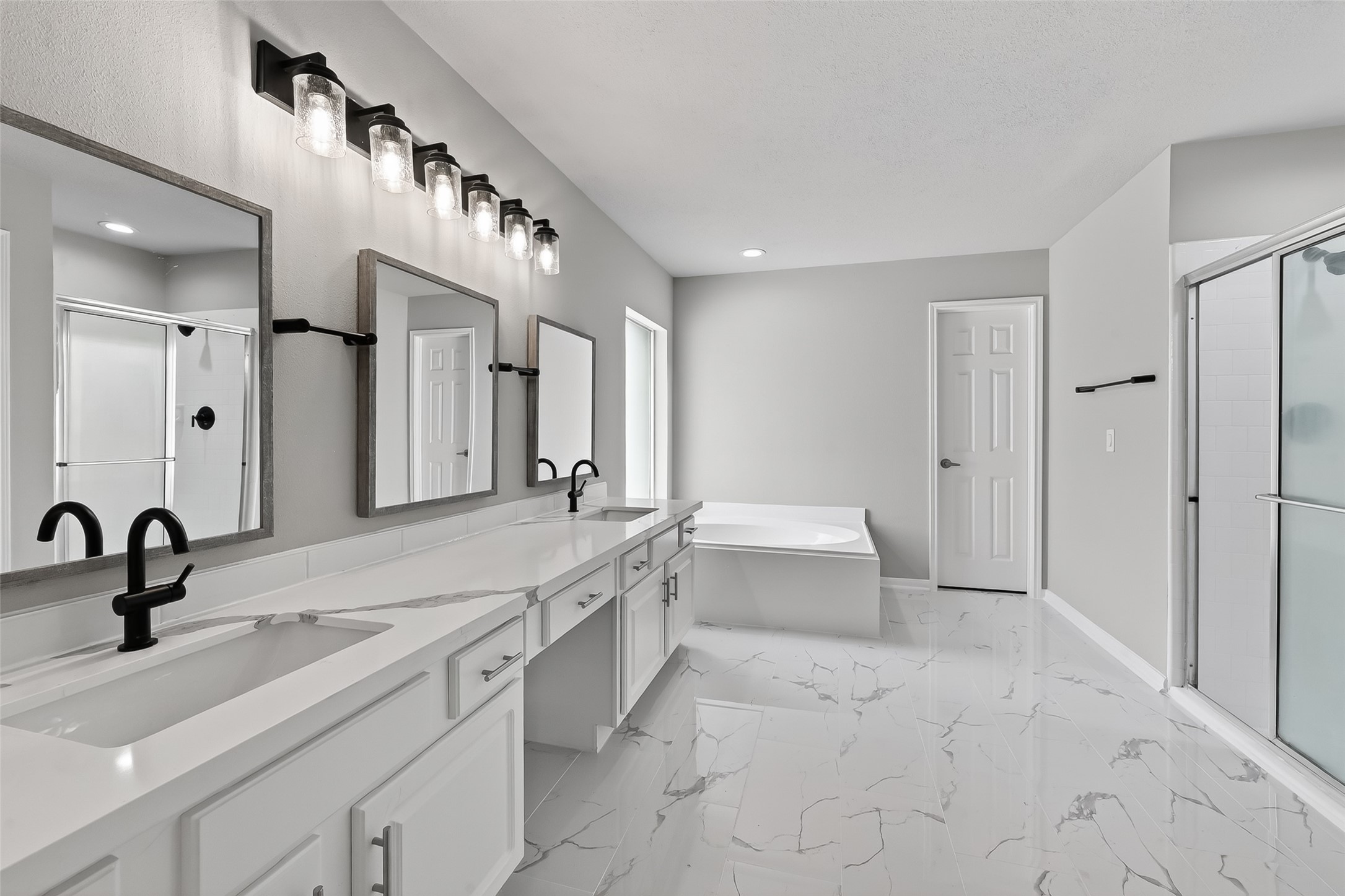 18058 Golden Ridge Drive Houston, TX 77084 - Photo 22 of 35 a spacious bathroom with a double vanity sink mirror and bathtub