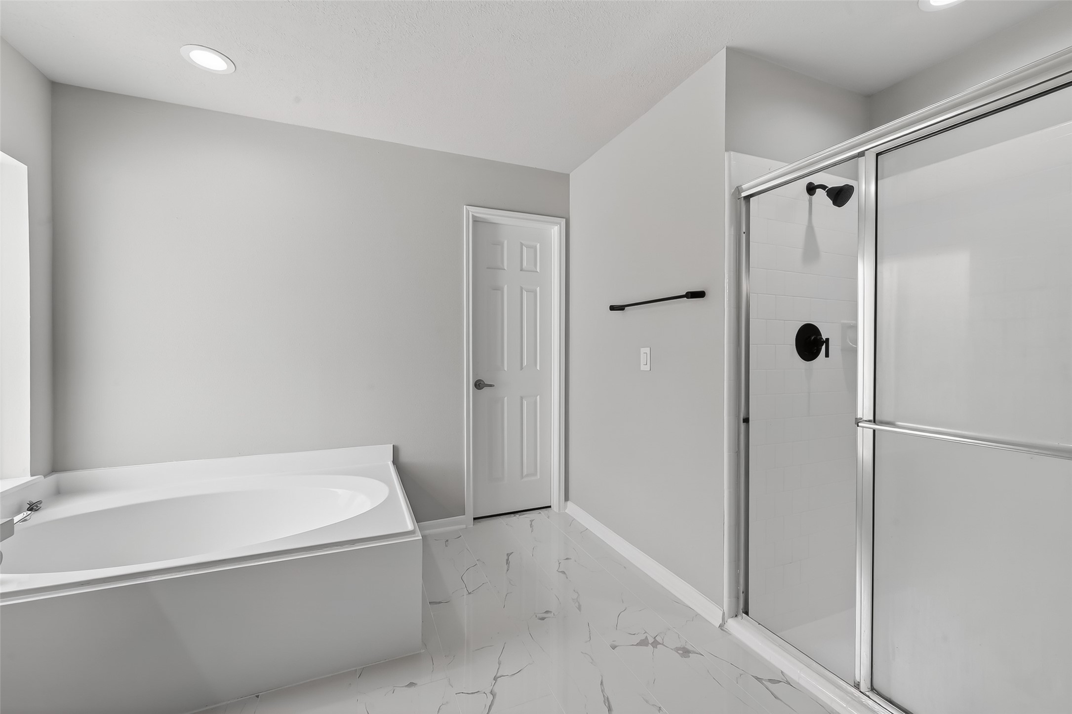 18058 Golden Ridge Drive Houston, TX 77084 - Photo 23 of 35 a bathroom with a bathtub and a shower