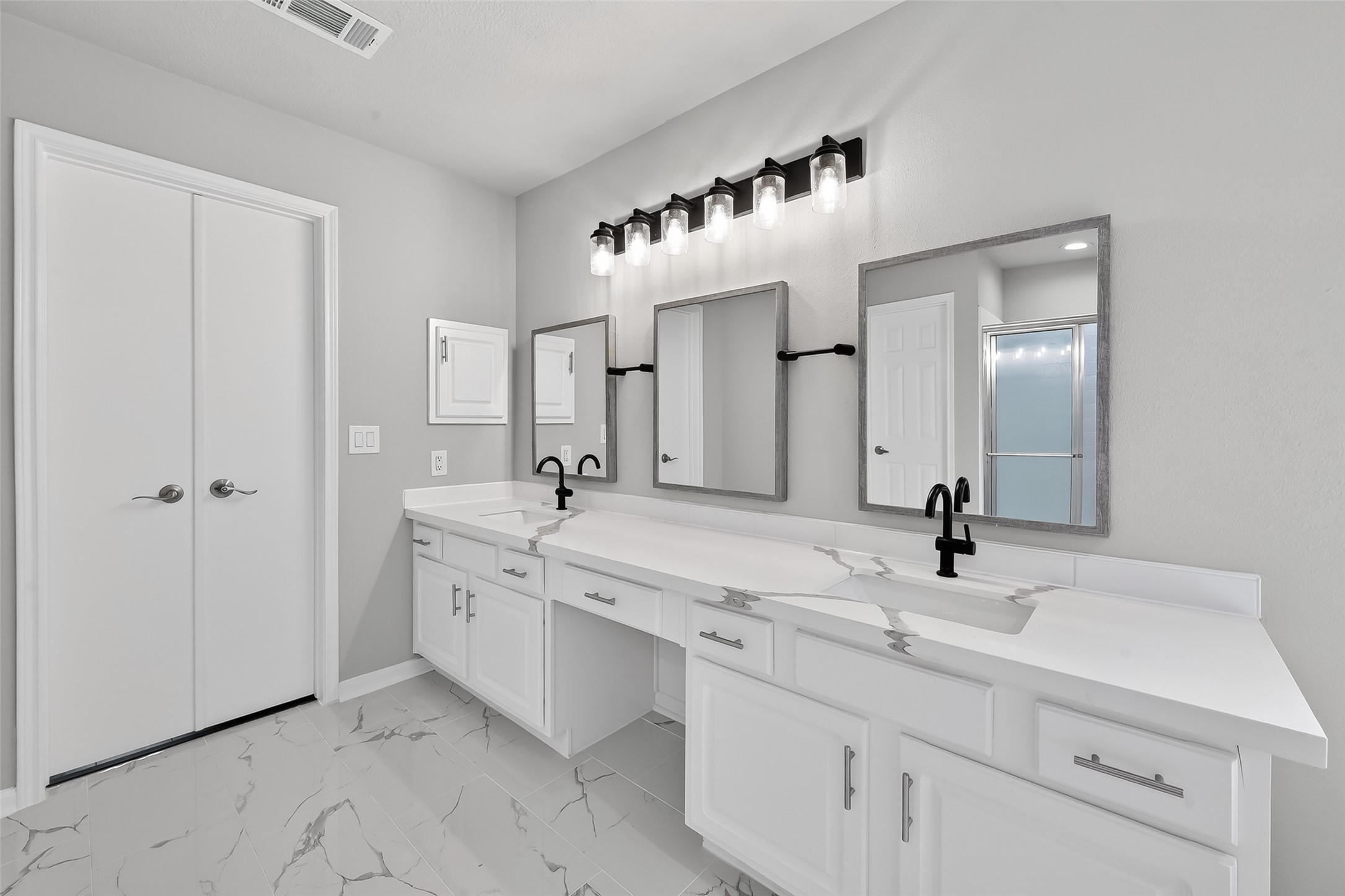18058 Golden Ridge Drive Houston, TX 77084 - Photo 24 of 35 a bathroom with a double vanity sink and a mirror