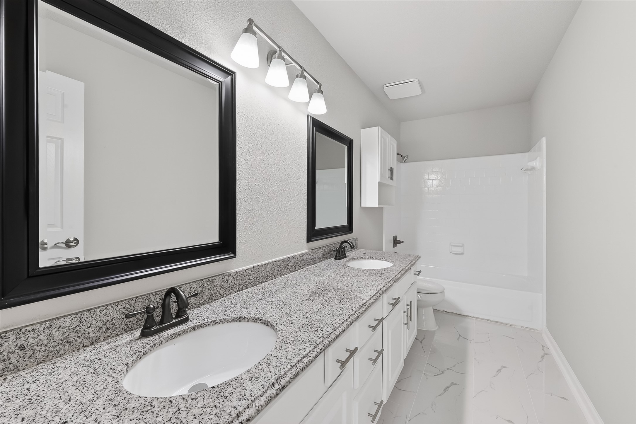 18058 Golden Ridge Drive Houston, TX 77084 - Photo 26 of 35 a bathroom with a granite countertop sink and a mirror
