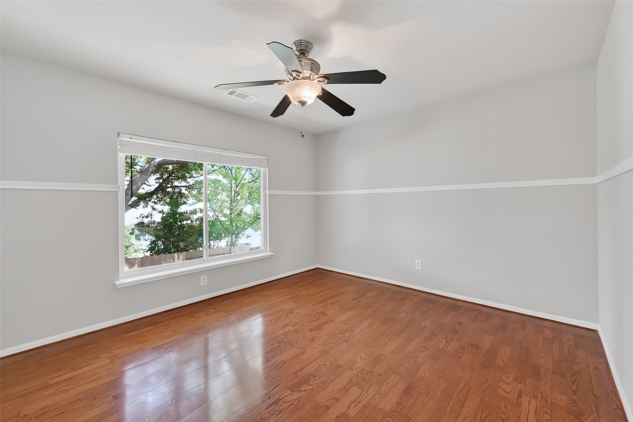 18058 Golden Ridge Drive Houston, TX 77084 - Photo 31 of 35 an empty room with a window and a fan