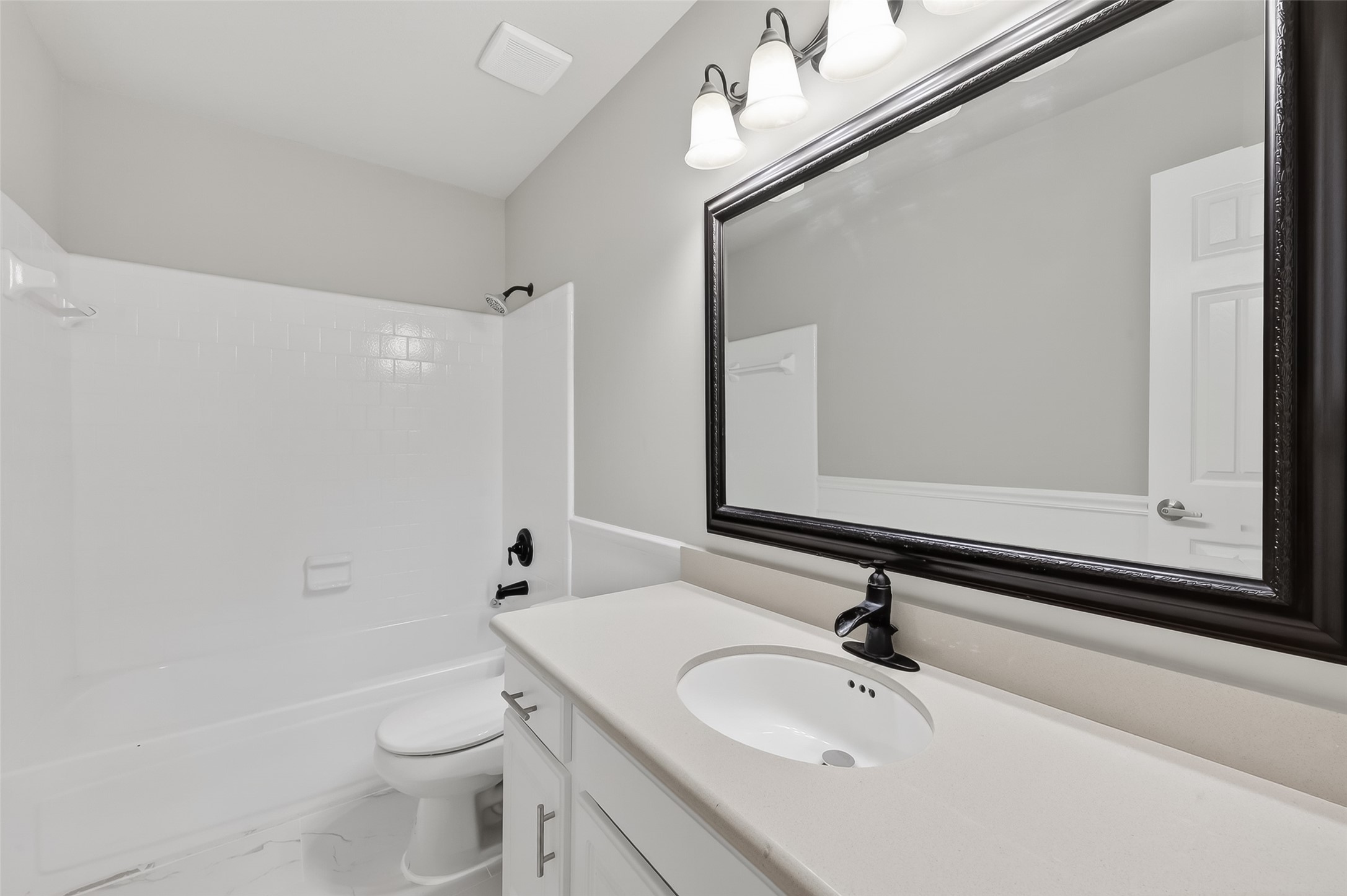 18058 Golden Ridge Drive Houston, TX 77084 - Photo 33 of 35 a bathroom with a sink a toilet and a mirror