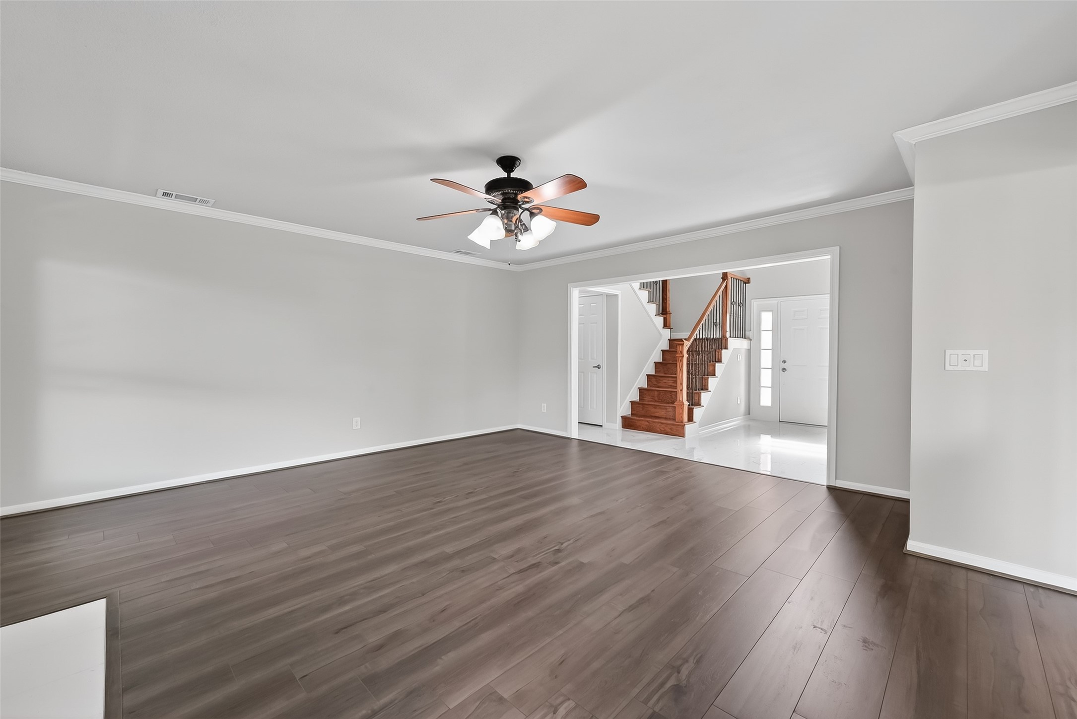 18058 Golden Ridge Drive Houston, TX 77084 - Photo 9 of 35 a view of a room with wooden floor and ceiling fan