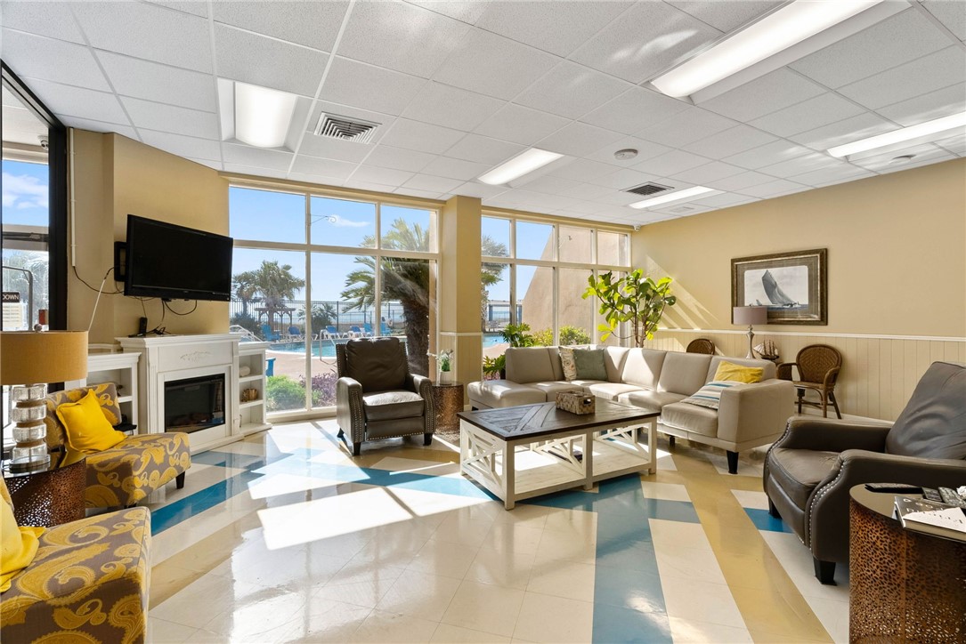 4000 Surfside Boulevard, Unit 508 Corpus Christi, TX 78402 - Photo 22 of 32 a living room with fireplace furniture and a flat screen tv