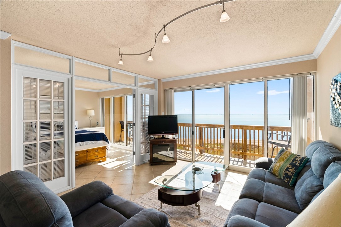 4000 Surfside Boulevard, Unit 508 Corpus Christi, TX 78402 - Photo 7 of 32 a living room with furniture and a flat screen tv