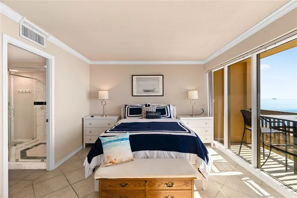 a bedroom with a bed and glass door