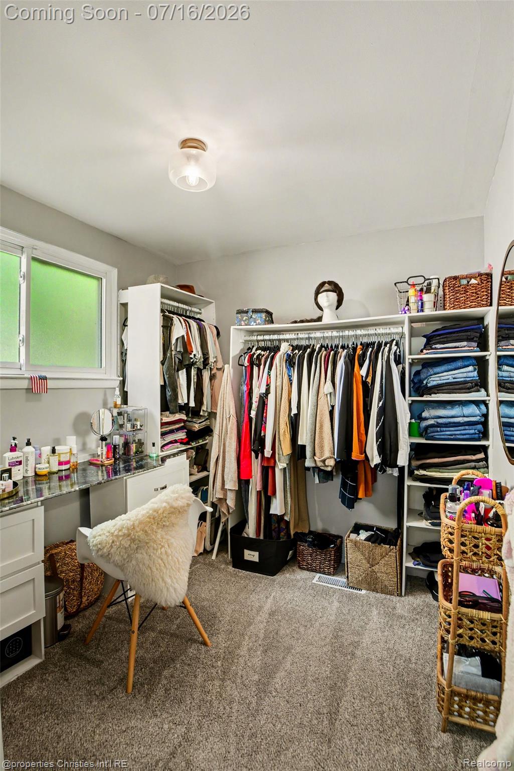 3304 Riverside Drive Port Huron, MI 48060 - Photo 12 of 26 Spacious closet featuring extensive built-in shelving, hanging rods, and soft carpet flooring