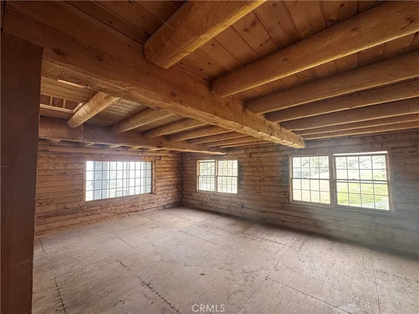 a view of an empty room with windows